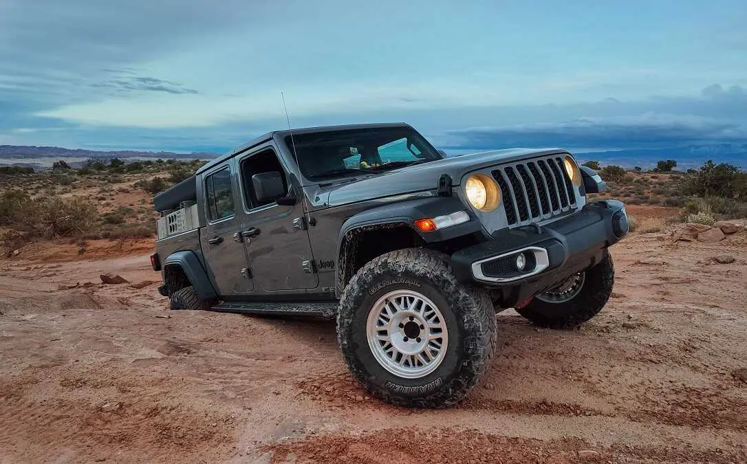 Nissan truck with ASFIR rock sliders on a red dirt trail