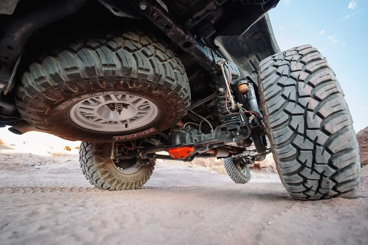Nissan truck flexing with ASFIR skid plates and red diff guard